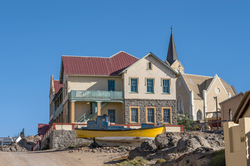old boat ashore and picturesque building at historical town, Luderitz,  Namibia