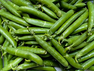 Top view of Young peas flower in the Local Wholesale Market. Healthy and green food. Fresh green peas. Pods of green organic peas on the Cart. City: Karachi, Pakistan.