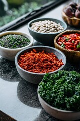 Bowls of superfoods including goji berries and beans displayed on a modern kitchen counter