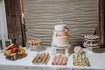 Candy bar at a wedding. Delicious desserts. Beautiful decorations. Fruits. Sweet cakes on your holiday. Birthday. Sweet life.
