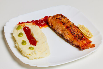 salmon prepared in the oven on a plate ready to be eaten.