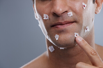 Man, cuts and skincare with close shave, grooming and morning routine on grey studio background....