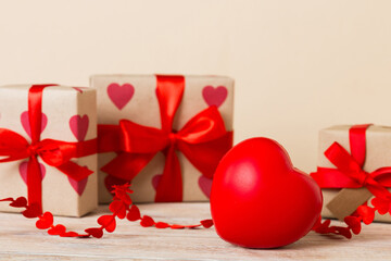 gift box with red bow and red heart on colored background. Perspective view. Flat lay