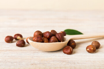 Wooden bowl full of hazelnuts on table background. Healthy eating concept. Super foods