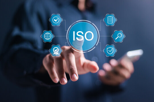 ISO standards quality control. Businessman use smartphone and hand touching virtual icon of quality assurance or guarantee product. ISO Standard certification. Modern ISO banner.