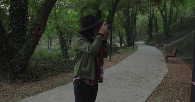 Girl taking photos in the park