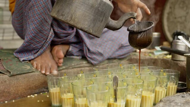 Indian Man Putting Water on Tea Leaves To make Tea