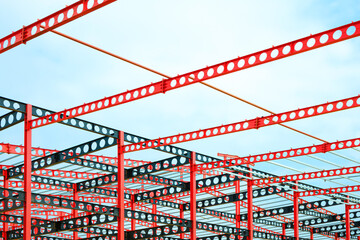 Red and black cellular beam metal outline of large Industrial building structure in construction...
