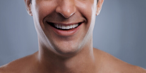 Man, mouth and smile with skincare and lips with hygiene, jawline and satisfaction with treatment closeup. Grooming, confidence and cropped with male model in studio background for cosmetics - obrazy, fototapety, plakaty