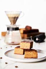 Sweet Breakfast concept. Blondies bars with v60 filter coffee, light background, airy mood food photo