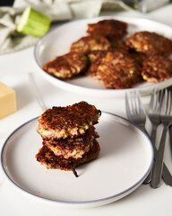 Beef, zucchini and cheddar cheese patties or cutlets on white plate. Dinner meat concept, full of proteins. 