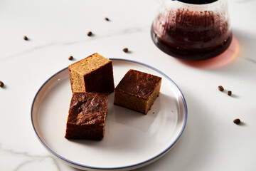 Sweet Breakfast concept. Blondies bars with v60 filter coffee, light background, airy mood food photo