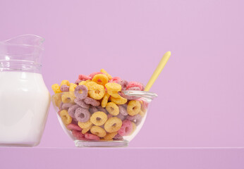 Breakfast cereal with colorful rings in a glass bowl. Fresh milk and good nutrition. Copy space for text.