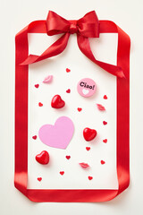 Red ribbon shaped like valentine card on light background. Top view.