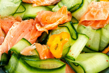 Fresh fish salad with raw cucumber.