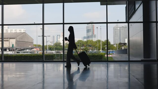 Beautiful Woman Confidently Going Near the Gates, Carrying Luggage and Coffee, Getting Ready for Flight in Airport Terminal. Female Tourist with Baggage Walking to Gate. Travel and Airport Concept
