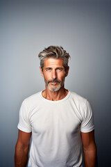Middle-aged handsome man with beard portrait, wearing white t-shirt