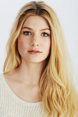 Naklejka premium Portrait, beauty and hair with natural woman in studio on white background for makeup or cosmetics. Face, skincare and aesthetic with confident young blonde model at salon or spa for haircare