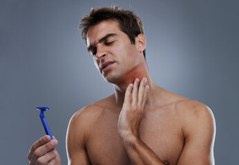 Man, shaving and beard or razor pain for hair removal or red rash, inflammation or grey background....