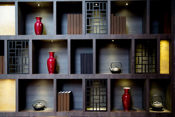 The wooden cabinets on the wall along with various Chinese-style decorations