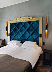 Elegant boutique hotel room with modern sconces and luxury bedding