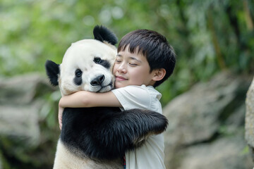 Young boy warmly embracing a cute baby panda