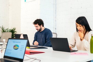 Group of multiracial people working with laptop in a coworking