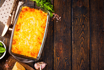 Rectangular glass bowl filled with mashed potato, underneath which is fish in cheese sauce. - 720308100