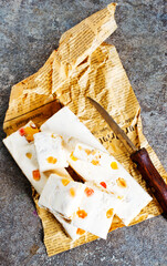 Pieces of delicious nutty nougat on table - 720308389