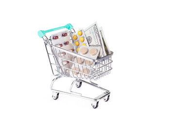 Medical shopping concept: shopping cart with pills on white background