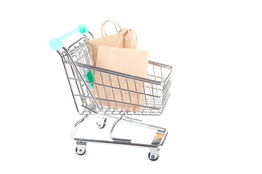 Shopping Cart with Paper Bags on White Background