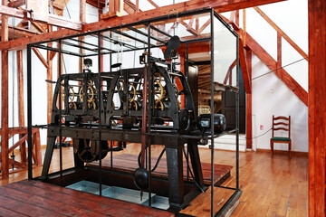 Clock mechanism in the tower. Metal wheels and rivets.