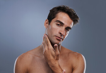 Portrait, glow and man with skincare, shaving and dermatology on grey studio background. Face,...