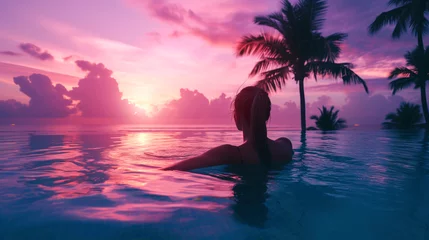 Keuken spatwand met foto Silhouette of woman relaxing in swimming pool at sunset time. © Faith Stock