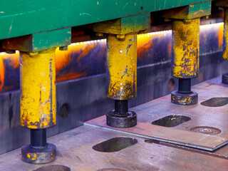 Hydraulic metal bending machine in selective focus in a metallurgical plant.Machine for stamping...