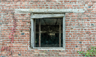 Fototapeta na wymiar empty window of an old brick building