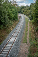 Obraz premium Dardilly, France - 08 05 2023: View of a railway track across the forest.