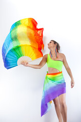 Beautiful woman dancing isolated on a white background with a colorful fan in her hand