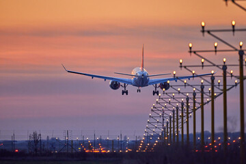 Passenger plane is landing during a wonderful sunset