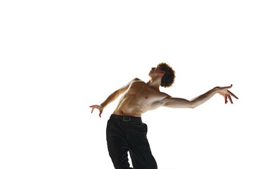 Balance. Young flexible bared man, ballet dancer performing contemporary dance against white studio...