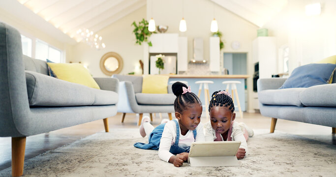 Black girl children on ground with tablet and relax, elearning or watch cartoon movie, sisters at home and screen time. Young female kids, streaming online and subscription to education app or film