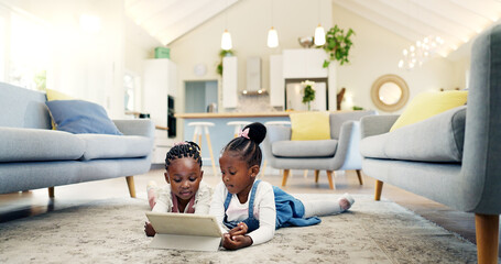 Black girl children on ground with tablet and relax, elearning or watch cartoon movie, sisters at...