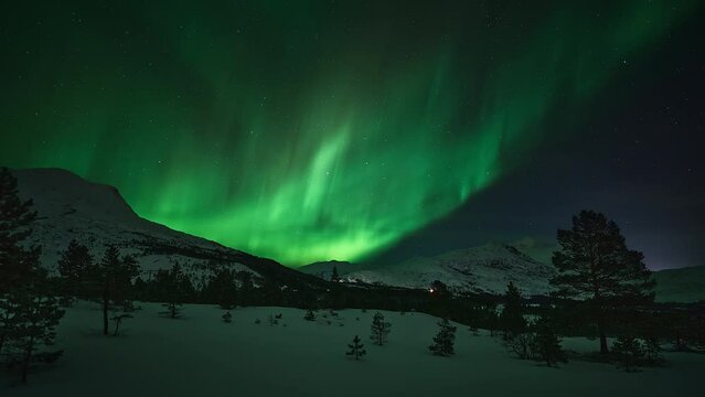 An impressive pulsing aurora lighting up a beautiful mountainus landscape in Bod&oslash;.