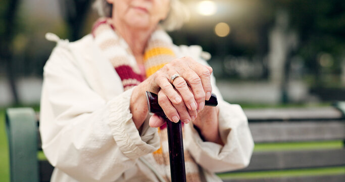 Walking stick, hands and senior woman closeup on a park bench with person with disability. Mobility support, wellness and balance with cane and elderly female person outdoor in a public garden - Powered by Adobe