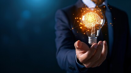 A businessman in a business suit holding a lit light bulb. The burning light bulb symbolizes an idea.