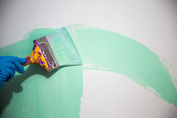 Brush the variegated color paint onto the weathered wooden plank wall