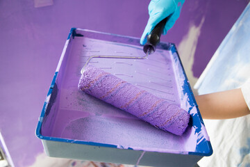 Brush the variegated color paint onto the weathered wooden plank wall