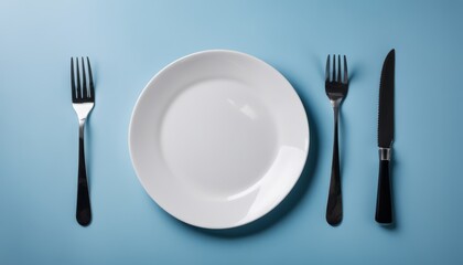 A white plate with a fork and knife on either side