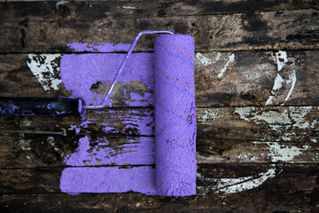 Brush the variegated color paint onto the weathered wooden plank wall