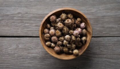 A wooden bowl filled with dried flowers